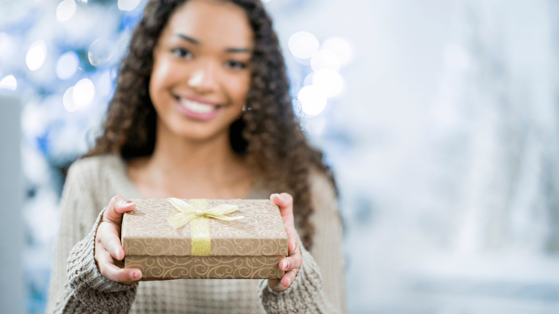 young woman offering gift for therapist in a holiday setting