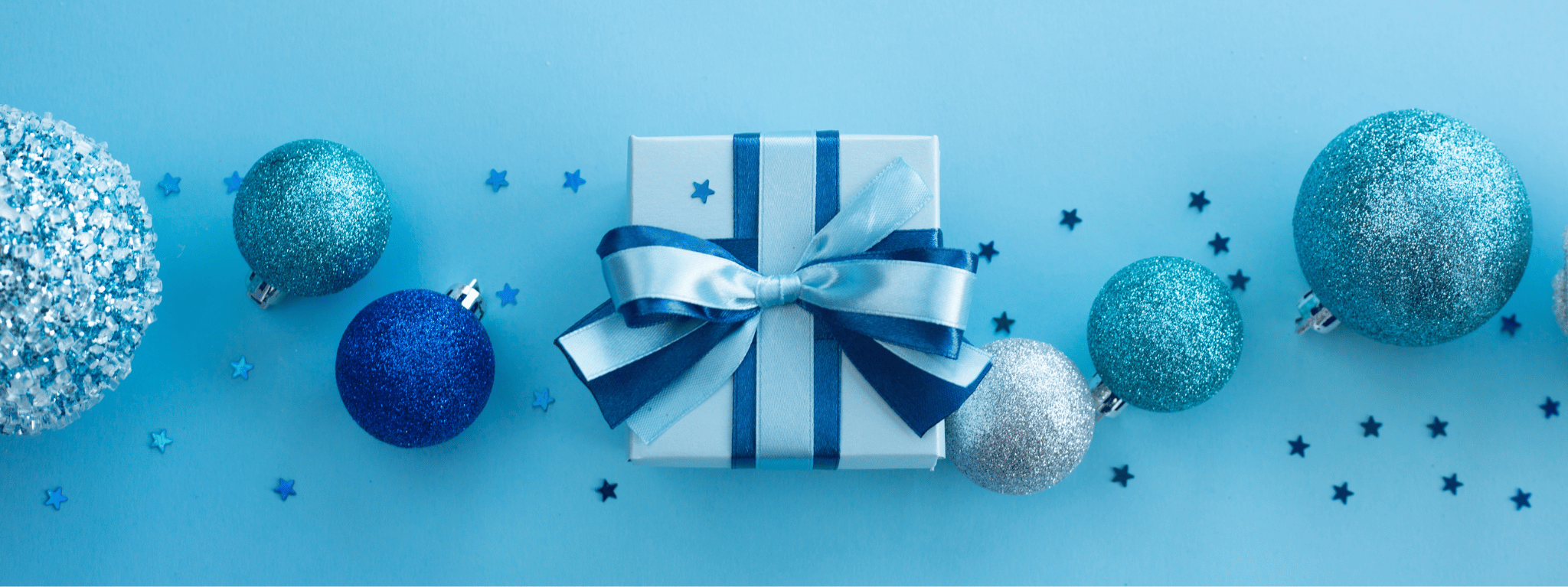 holiday giveaway background with blue and silver ornaments and a blue present and confetti
