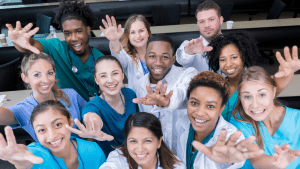 diverse group of new RNs reaching out to the camera